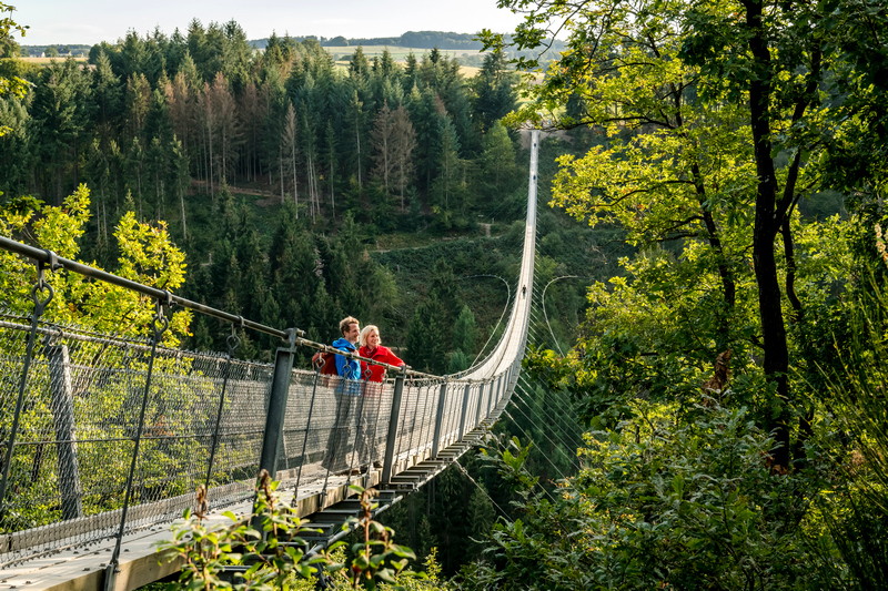 Title Saar Hunsrück Climb Couple hiking on the hanging rope bridge Geierlay